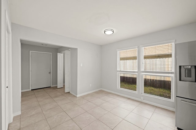 spare room featuring light tile patterned flooring