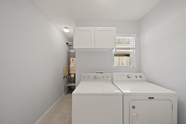 laundry room with independent washer and dryer, light tile patterned floors, and water heater