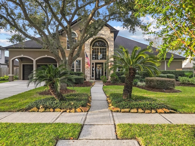 view of front of home featuring a garage and a front yard