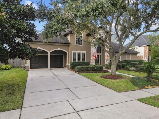 view of front of home with a front yard and a garage