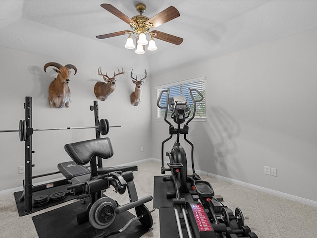 workout area with a textured ceiling, carpet floors, and ceiling fan