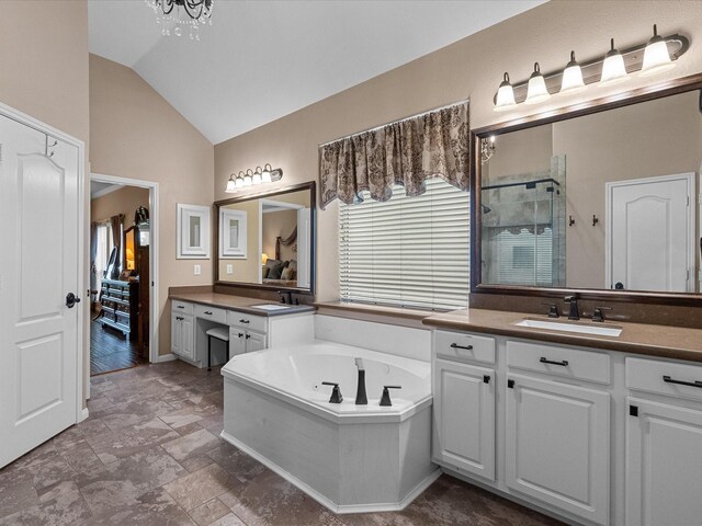 bathroom with plus walk in shower, vanity, vaulted ceiling, and a notable chandelier