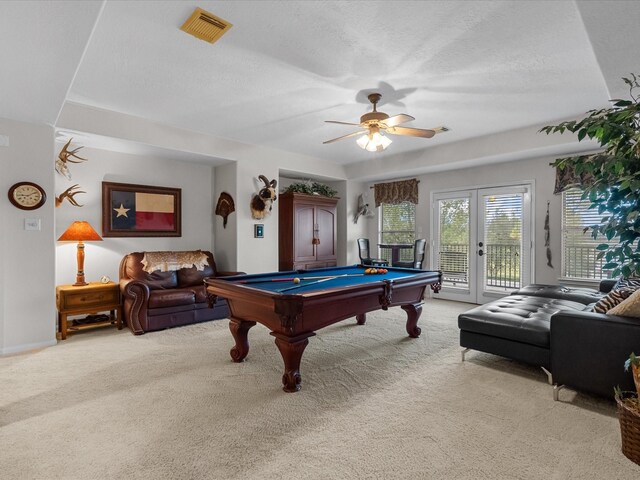 playroom with french doors, a textured ceiling, light colored carpet, ceiling fan, and pool table