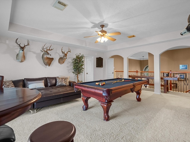 recreation room featuring a raised ceiling, ceiling fan, a textured ceiling, pool table, and carpet floors