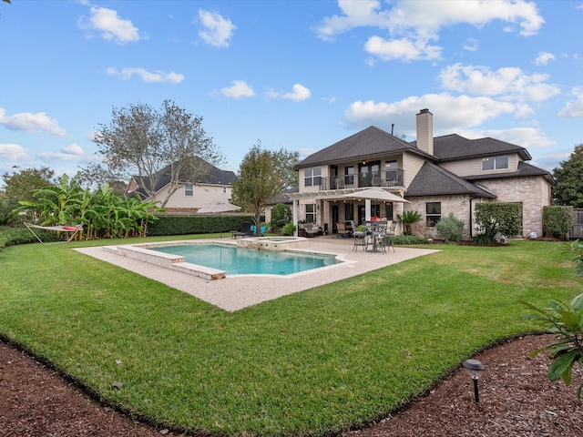 view of swimming pool featuring a lawn and a patio