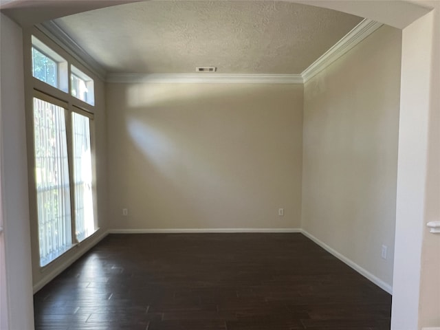 unfurnished room featuring dark hardwood / wood-style flooring, ornamental molding, and a textured ceiling