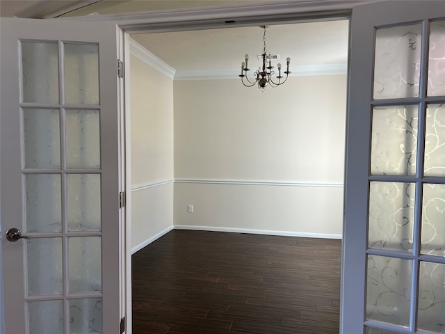 unfurnished room featuring a chandelier, crown molding, and dark wood-type flooring