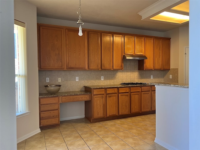 kitchen featuring light tile patterned flooring, a wealth of natural light, and tasteful backsplash