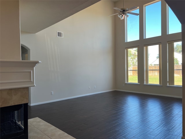 unfurnished living room with plenty of natural light, high vaulted ceiling, and wood-type flooring