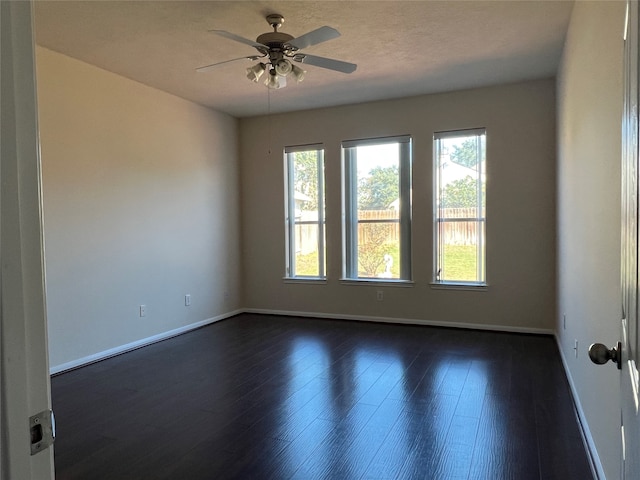 unfurnished room featuring ceiling fan and dark hardwood / wood-style flooring