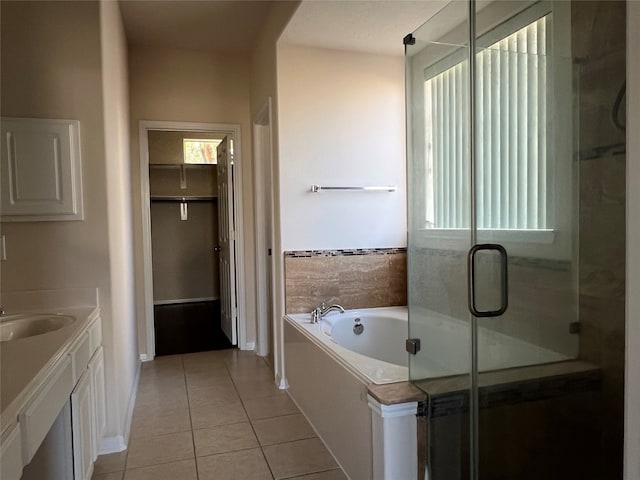 bathroom with tile patterned floors, vanity, and plus walk in shower