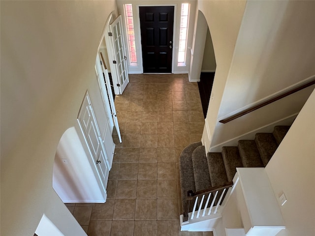 entryway with dark tile patterned flooring