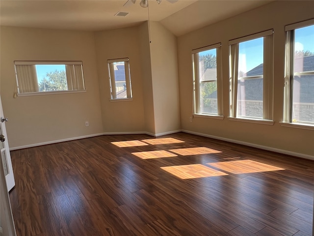 empty room with dark hardwood / wood-style floors, ceiling fan, and lofted ceiling