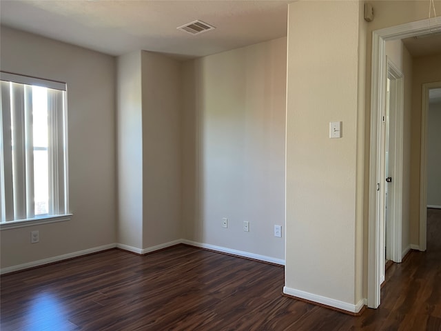 empty room with dark wood-type flooring