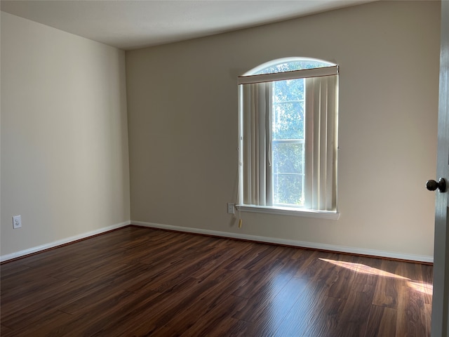 empty room featuring dark hardwood / wood-style flooring