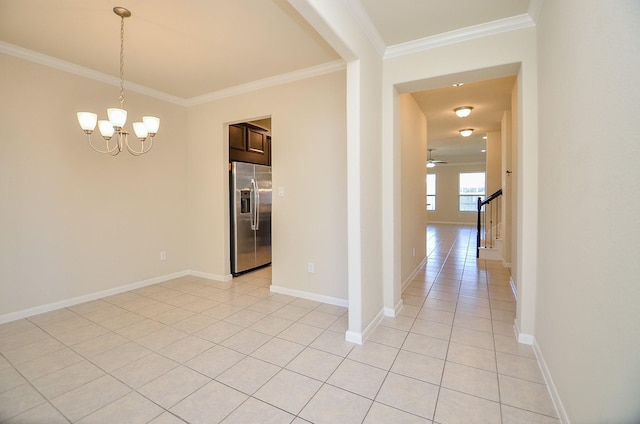 interior space featuring ceiling fan with notable chandelier, light tile patterned flooring, and ornamental molding