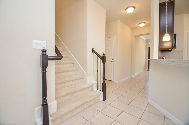 staircase featuring tile patterned flooring