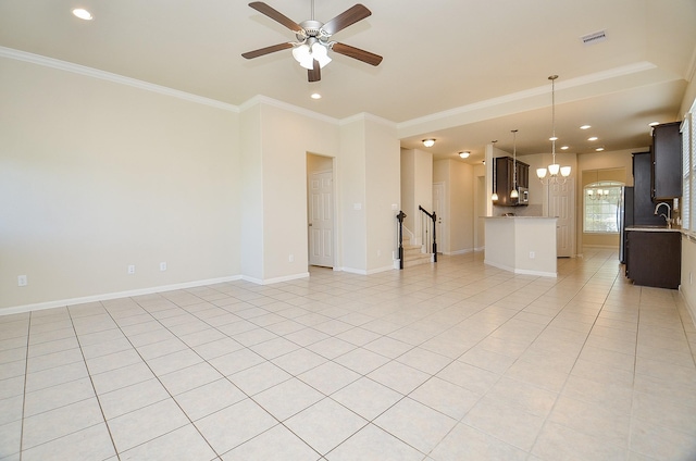 tiled empty room with crown molding, sink, and ceiling fan with notable chandelier