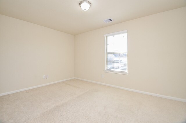 empty room featuring light colored carpet