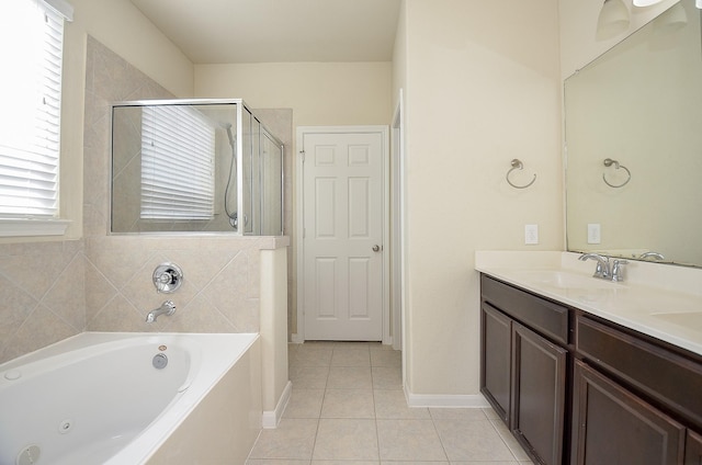 bathroom featuring plus walk in shower, vanity, and tile patterned floors