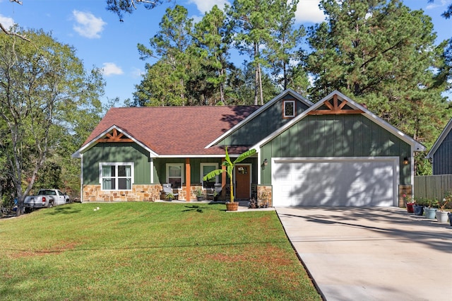 craftsman-style house featuring a porch, a garage, and a front yard