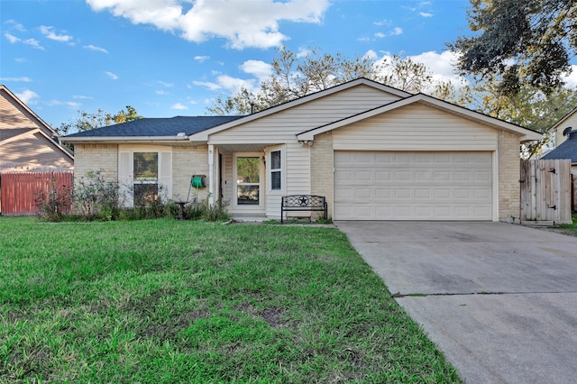 single story home with a front yard and a garage