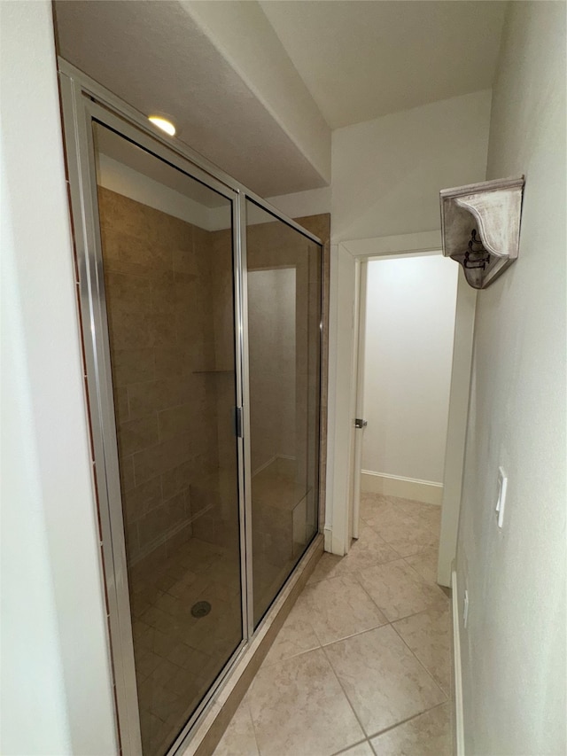 bathroom with tile patterned floors and an enclosed shower