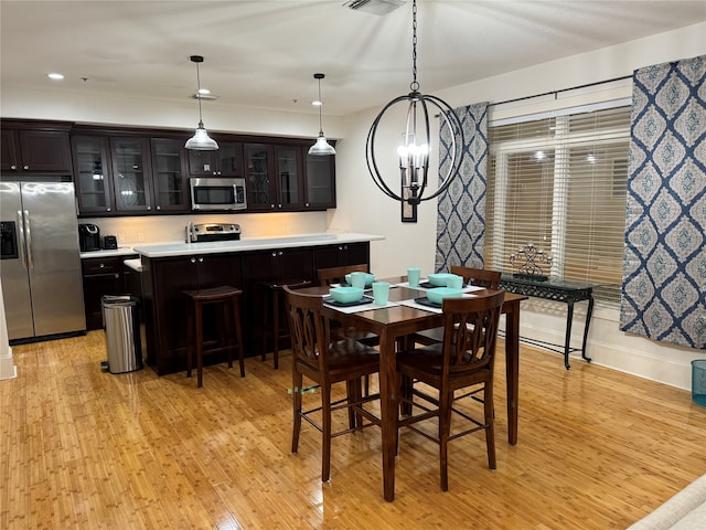 dining room featuring light hardwood / wood-style floors and an inviting chandelier