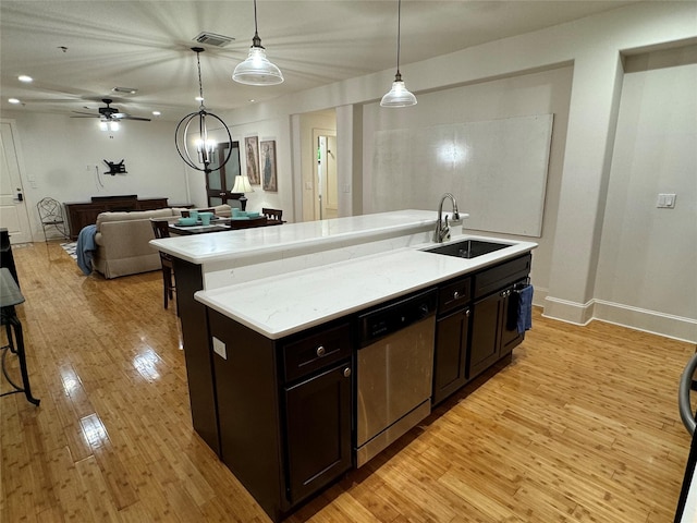 2208 Post Office St Unit 105, Galveston, TX 77550 - kitchen featuring dishwasher, light wood-style floors, open floor plan, a kitchen island with sink, and decorative light fixtures