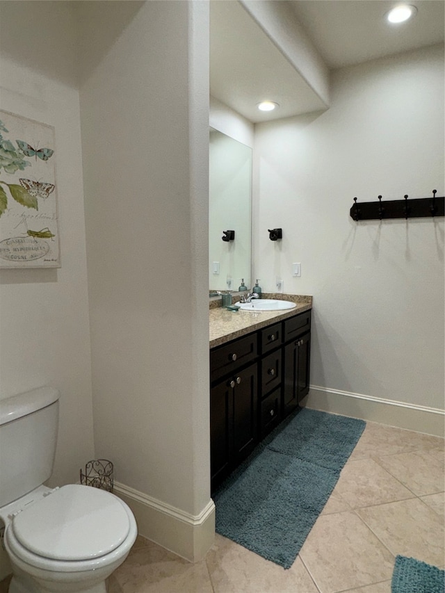 bathroom featuring tile patterned flooring, vanity, and toilet