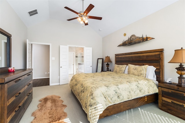 carpeted bedroom featuring connected bathroom, vaulted ceiling, and ceiling fan