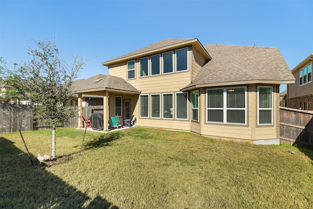 back of property featuring a patio and a yard