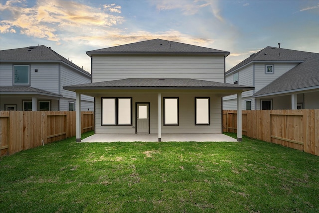 6703 Old Cypress Landing Ln, Humble, TX 77338 - back of property at dusk with a yard, a fenced backyard, and a patio