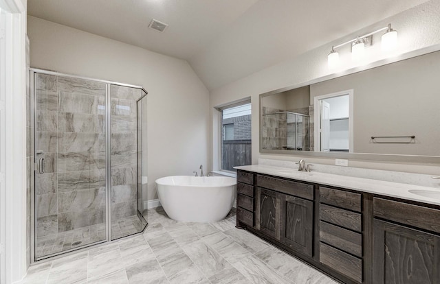 bathroom featuring plus walk in shower, vaulted ceiling, and vanity