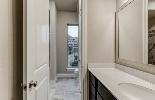 bathroom featuring vanity and toilet