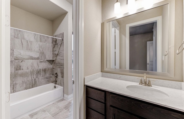 bathroom featuring vanity and tiled shower / bath