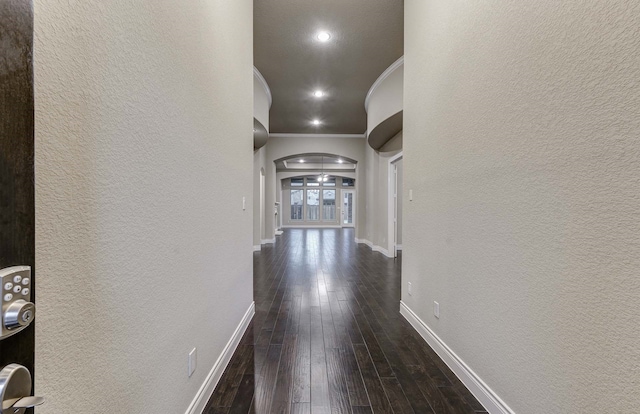 hall with dark hardwood / wood-style floors and crown molding