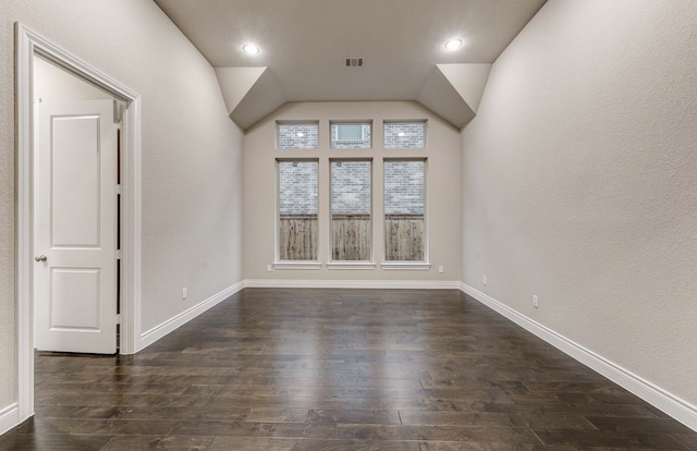 interior space featuring dark hardwood / wood-style floors and vaulted ceiling