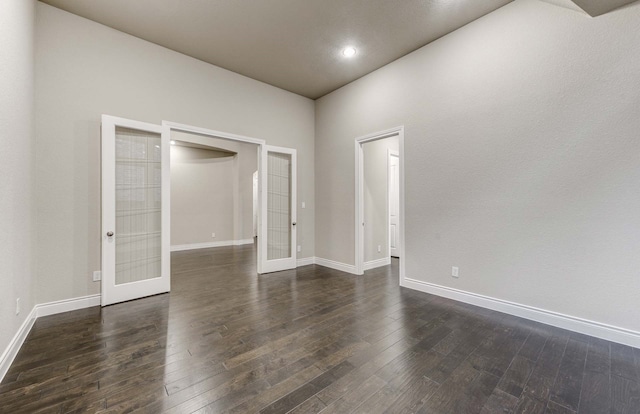 unfurnished room featuring french doors and dark hardwood / wood-style floors