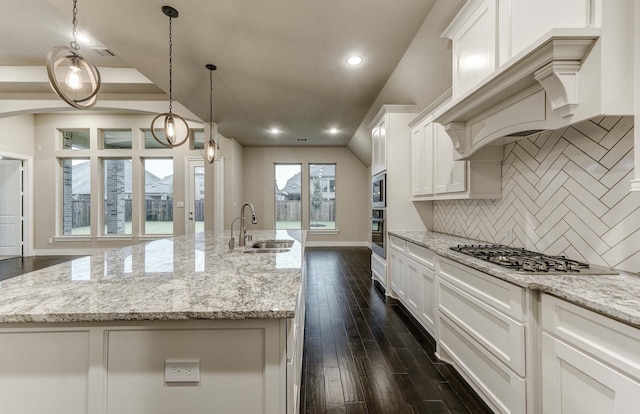 kitchen featuring white cabinetry, an island with sink, stainless steel appliances, and sink