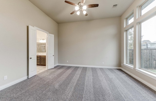 spare room featuring ceiling fan and light colored carpet