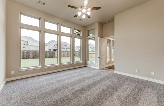 unfurnished room with ceiling fan and light colored carpet