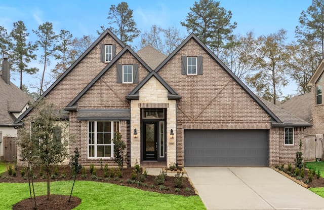 view of front of property with a garage and a front yard