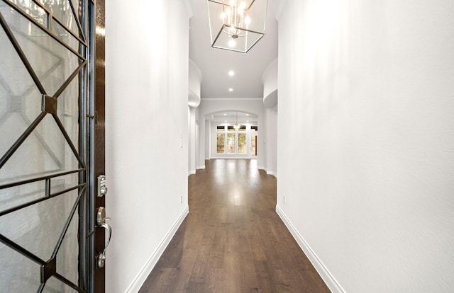 339 Calmato Woods Way, Willis, TX 77318 - hall featuring dark wood-style floors, crown molding, baseboards, arched walkways, and a chandelier