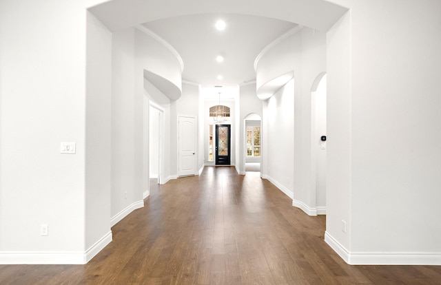 339 Calmato Woods Way, Willis, TX 77318 - corridor featuring arched walkways, dark wood finished floors, baseboards, and recessed lighting