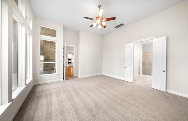 339 Calmato Woods Way, Willis, TX 77318 - unfurnished bedroom with carpet, baseboards, and a ceiling fan