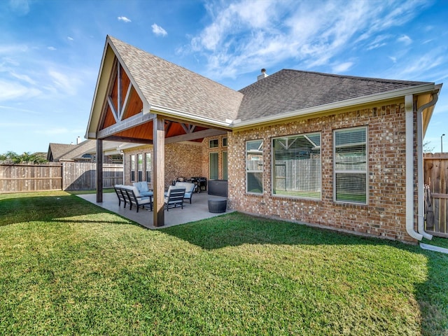 back of house featuring a lawn, a patio area, and an outdoor living space