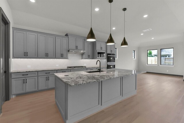 16179 Sheridan River Trl, Conroe, TX 77302 - kitchen with gray cabinets, a sink, appliances with stainless steel finishes, light wood-style floors, and recessed lighting