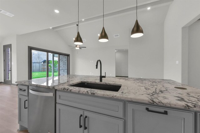 16179 Sheridan River Trl, Conroe, TX 77302 - kitchen with a sink, light stone counters, gray cabinetry, dishwasher, and pendant lighting
