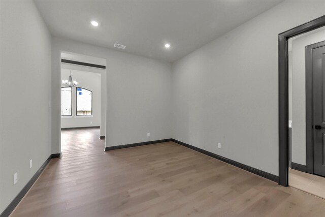 16179 Sheridan River Trl, Conroe, TX 77302 - unfurnished room with a chandelier, light wood-type flooring, recessed lighting, and baseboards